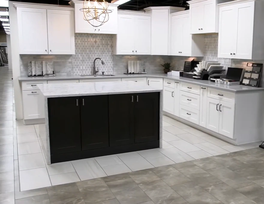 White kitchen countertops with black island cabinets.