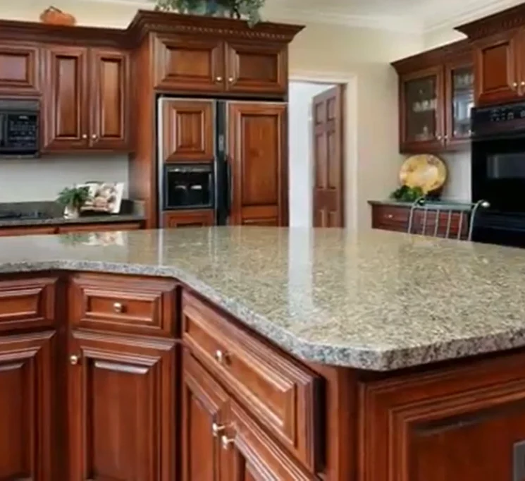 Granite countertops with dark wood kitchen cabinets.
